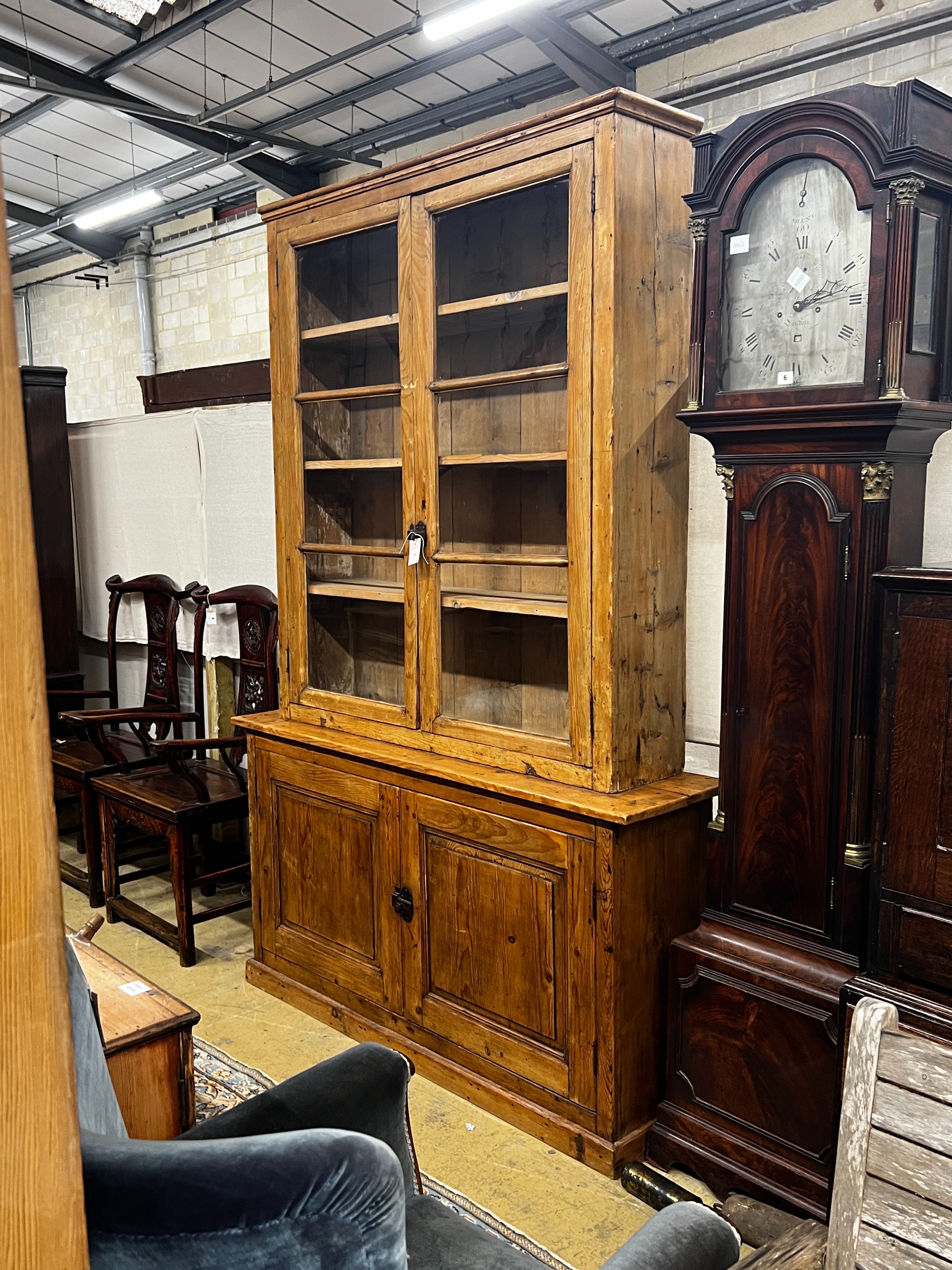 A 19th century French provincial pine two door glazed bookcase, length 151cm, depth 39cm, height 229cm